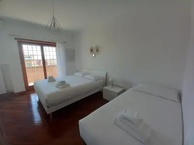 a bedroom with two beds and a window at St Peter's view penthouse 300 mt metro A stop in Rome