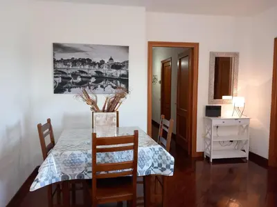 a dining room with a table and chairs and a mirror at St Peter's view penthouse 300 mt metro A stop in Rome