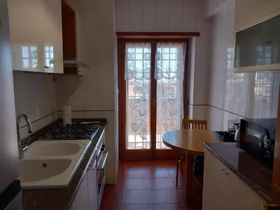 a kitchen with a sink and a stove and a window at St Peter's view penthouse 300 mt metro A stop in Rome