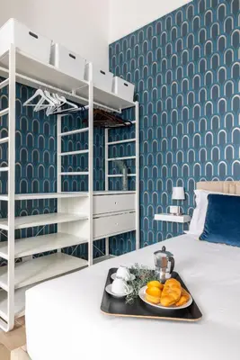 a bedroom with a tray of food on a bed at Gianicolo Trastevere Exclusive Apartments in Rome