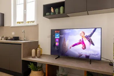 a flat screen tv sitting on a counter in a kitchen at Gianicolo Trastevere Exclusive Apartments in Rome
