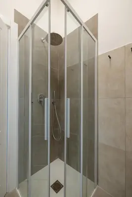 a shower with a glass door in a bathroom at Gianicolo Trastevere Exclusive Apartments in Rome