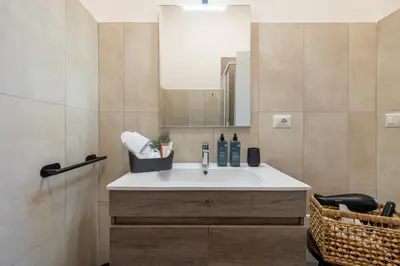 a bathroom with a sink and a mirror at Gianicolo Trastevere Exclusive Apartments in Rome
