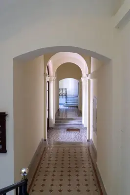 a hallway with an archway in a building at Rossovino a Roma in Rome