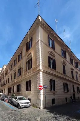 a large building with cars parked in front of it at Rossovino a Roma in Rome