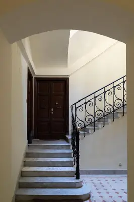 an empty hallway with stairs and a door at Rossovino a Roma in Rome