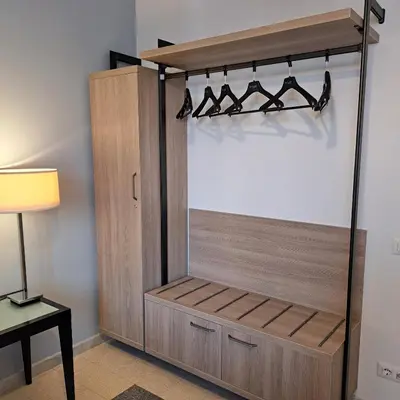 a closet with a wooden cabinet and a lamp at Giovanni Home Porta Metronia in Rome