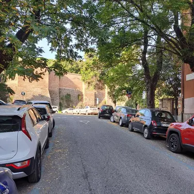 a row of cars parked on the side of a street at Giovanni Home Porta Metronia in Rome