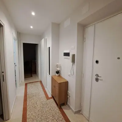 a hallway with white walls and a phone on the wall at Giovanni Home Porta Metronia in Rome