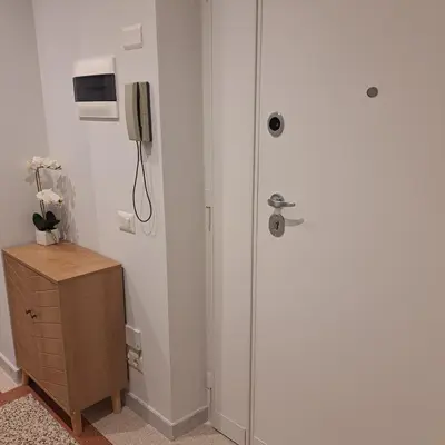 a door in a room with a phone on the wall at Giovanni Home Porta Metronia in Rome