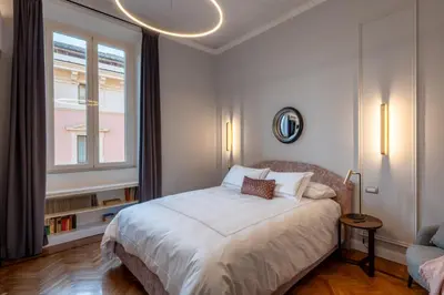 a white bedroom with a bed and a window at Migliori Collection Suites Via Veneto in Rome