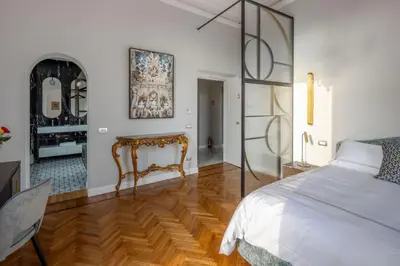 a bedroom with a bed and a table at Migliori Collection Suites Via Veneto in Rome