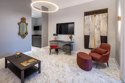 a living room with a desk and a chair at Migliori Collection Suites Via Veneto in Rome