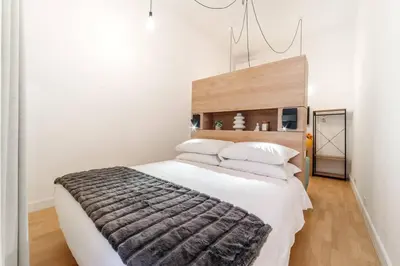 a bedroom with a large white bed with a brown blanket at Casa Trilussa Luxury House with Terrace in Trastevere in Rome
