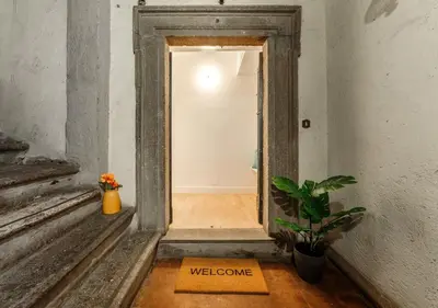 an open door with a welcome sign in a hallway at Casa Trilussa Luxury House with Terrace in Trastevere in Rome