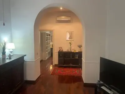 a hallway with an archway and a room with a television at Via Veneto e La Dolce Vita in Rome