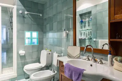 a bathroom with a toilet and a sink and a mirror at Via Veneto e La Dolce Vita in Rome