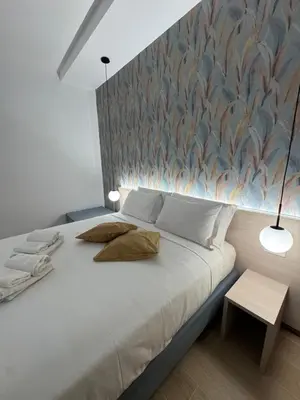 a bedroom with a large bed with a wall at NeW!The Place Vaticano 278 guest house in Rome