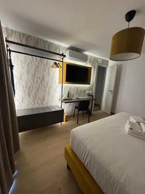 a bedroom with a bed and a desk in it at NeW!The Place Vaticano 278 guest house in Rome