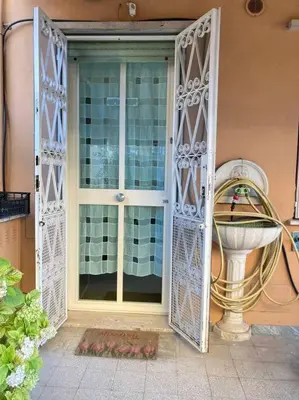 a front door of a house with a window at oreglia house in Rome