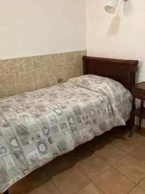 a bedroom with a bed with a blanket on it at oreglia house in Rome
