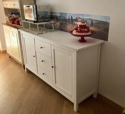 a white cabinet with a cake on top of it at oreglia house in Rome