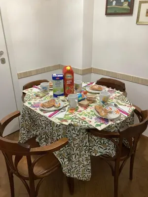 a table with plates of food and drinks on it at oreglia house in Rome