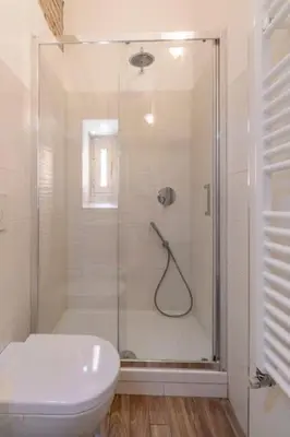 a bathroom with a shower with a toilet and a sink at 2 minutes from the Colosseum - Luxury apartment in Rome