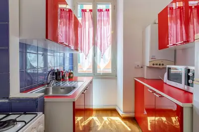 a kitchen with a sink and a microwave at 2 minutes from the Colosseum - Luxury apartment in Rome