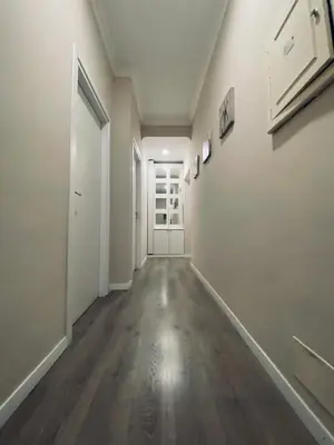 an empty hallway with white walls and wood floors at Stephany's Guesthouse in Rome