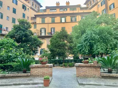 a large building with trees and plants in a courtyard at Andreoli 2 apartment Rooftop in Rome