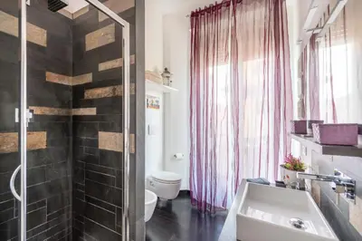a bathroom with a sink and a toilet and a shower at Andreoli 2 apartment Rooftop in Rome