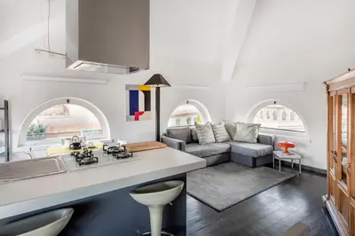 a kitchen and living room with white walls and arched windows at Andreoli 2 apartment Rooftop in Rome