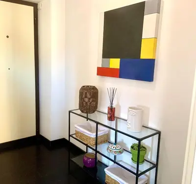 a shelf in a room with a painting on the wall at Andreoli 2 apartment Rooftop in Rome