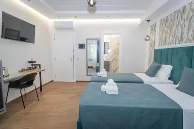 a hotel room with two beds and a desk at La Genziana in Rome
