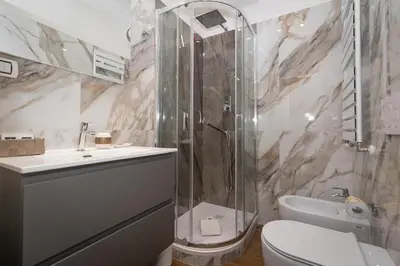a bathroom with a shower and a toilet and a sink at La Genziana in Rome