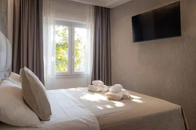 a bedroom with two towels on a bed with a window at La Genziana in Rome
