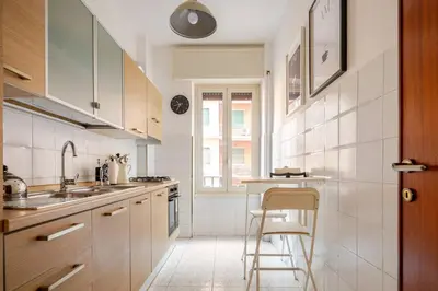a white kitchen with a sink and a counter at Vespa s house 10 minuti Musei Vaticani in Rome
