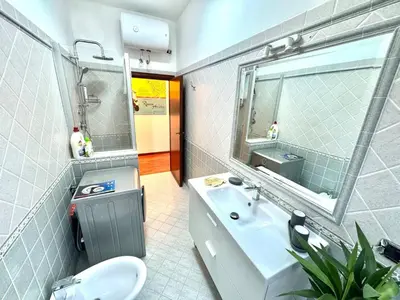 a bathroom with a sink and a toilet and a mirror at Vespa s house 10 minuti Musei Vaticani in Rome