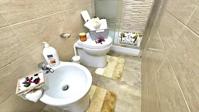 a bathroom with a white toilet and a sink at A Casa Simpatia Vaticano in Rome