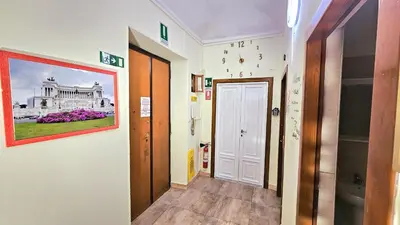 a hallway with a painting of a white building at A Casa Simpatia Vaticano in Rome