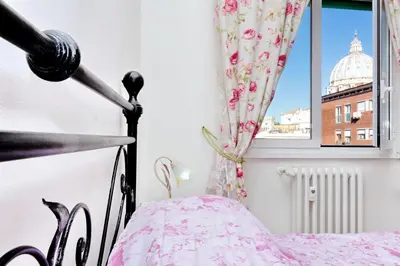 a bedroom with a bed and a window at Il Bacio Holidayhouse BEST LOCATION FOR VISIT THE VATICAN in Rome