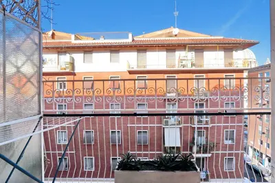 a large red brick building in a city at Il Bacio Holidayhouse BEST LOCATION FOR VISIT THE VATICAN in Rome