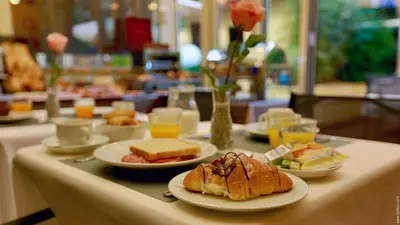 a table with plates of food on a table at Hotel Giolitti in Rome