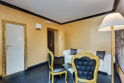 a living room with a couch and a table and chairs at Spanish Steps Boutique Gold Apartment in Rome