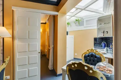 a room with a kitchen with a table and a window at Spanish Steps Boutique Gold Apartment in Rome
