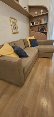 a large couch in a living room with a wooden floor at Casa Capponi - A San Pietro in Rome