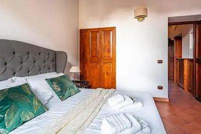 a bedroom with a bed with towels on it at iFlat Colosseum & Monti Cozy Bright Dream in Rome
