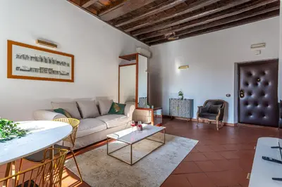 a living room with a couch and a table at iFlat Colosseum & Monti Cozy Bright Dream in Rome