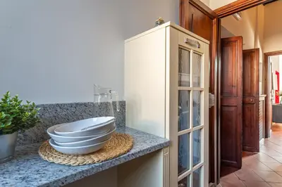 a kitchen with a bowl on a counter with a cabinet at iFlat Colosseum & Monti Cozy Bright Dream in Rome